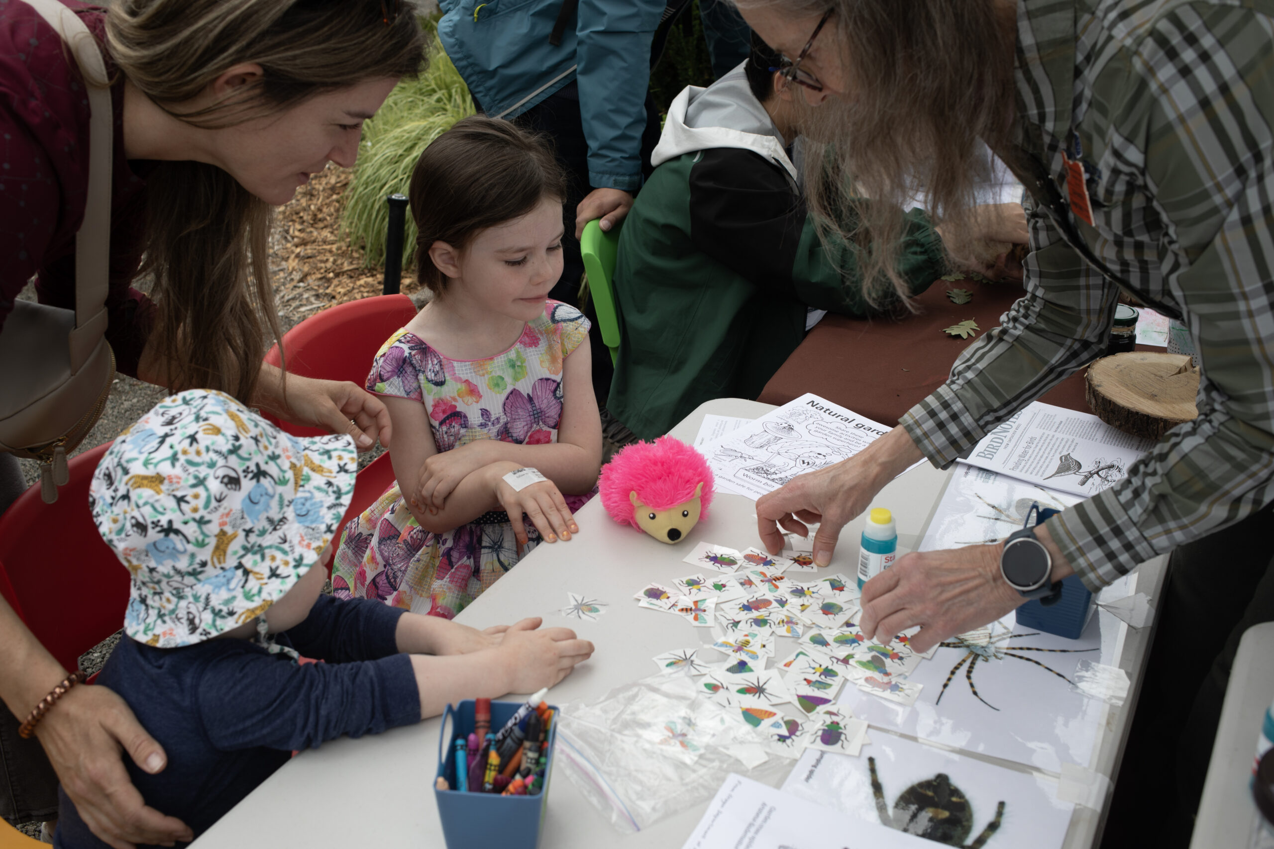 Children selecting insect tattoos